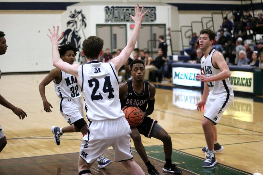 Ryan Ward drives into the paint during Round Rocks district battle with McNeil